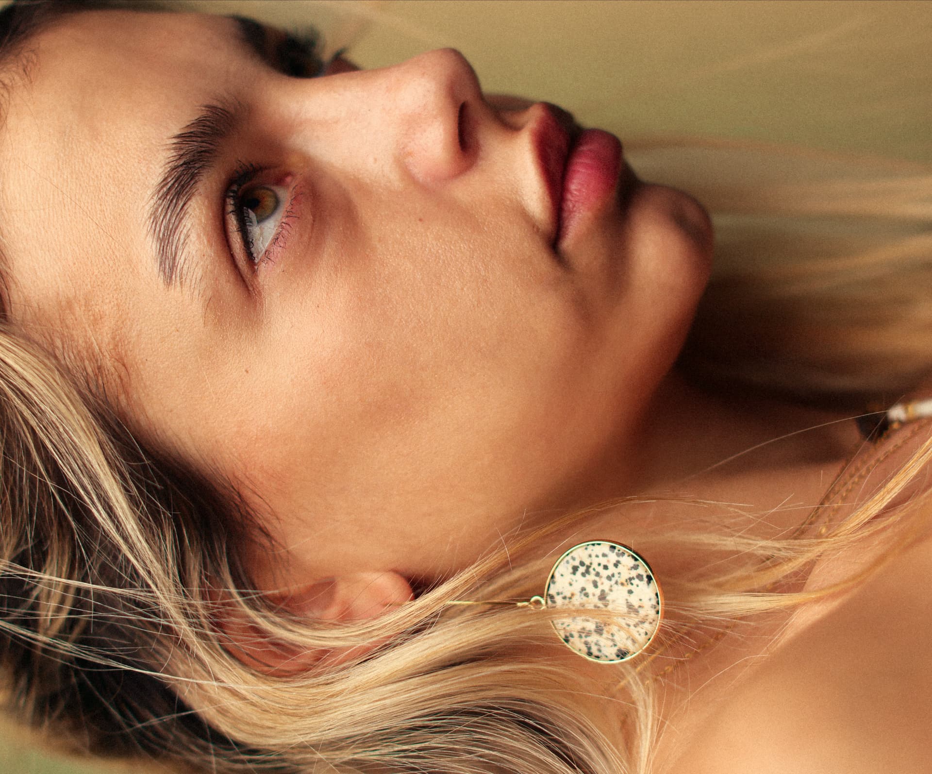 Close-up blonde portrait with long hair and round earring