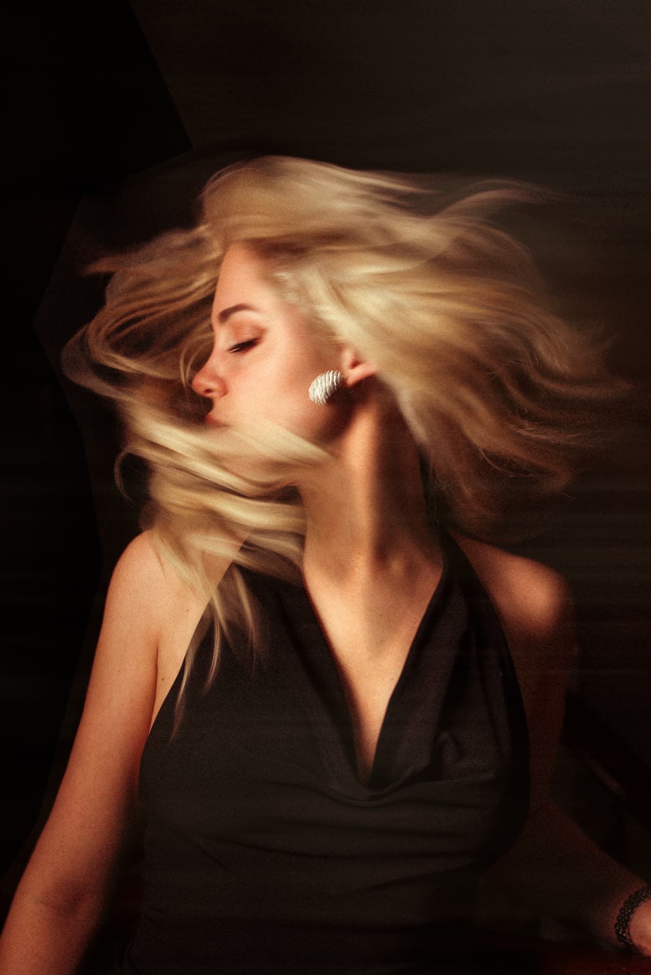 Blonde hair in motion under warm light