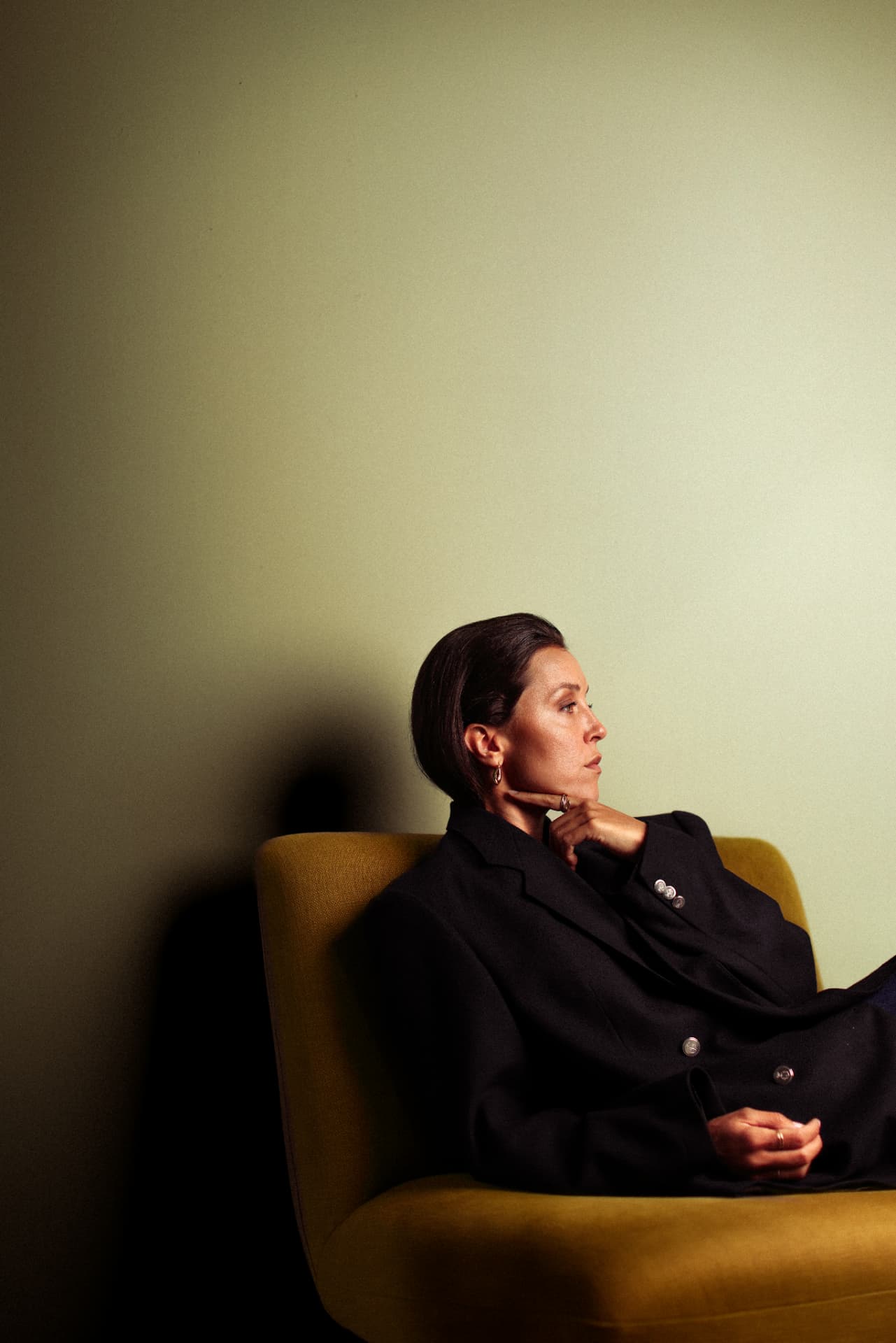 Seated profile portrait in mustard armchair