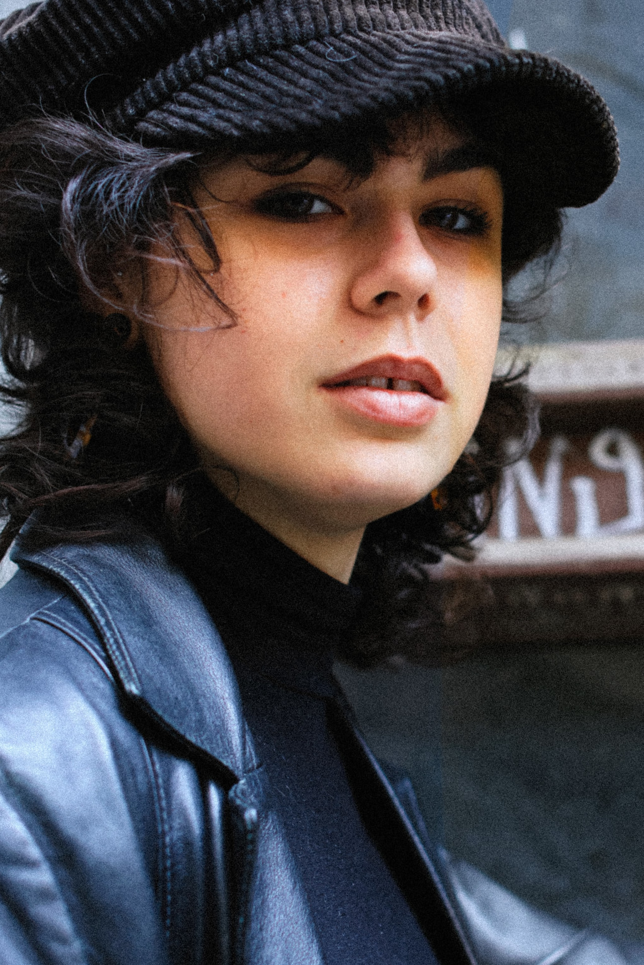 Street portrait in leather jacket and knit cap