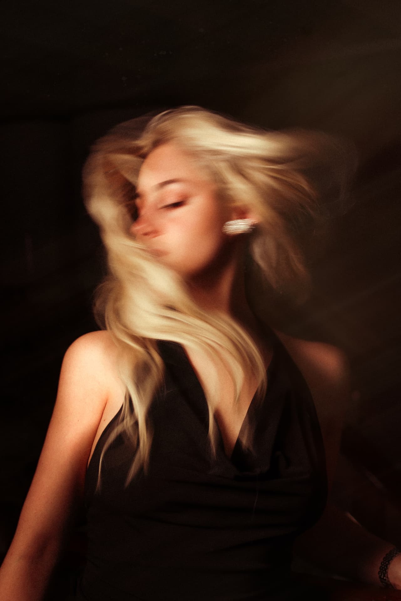 Blonde model with flowing hair in black top